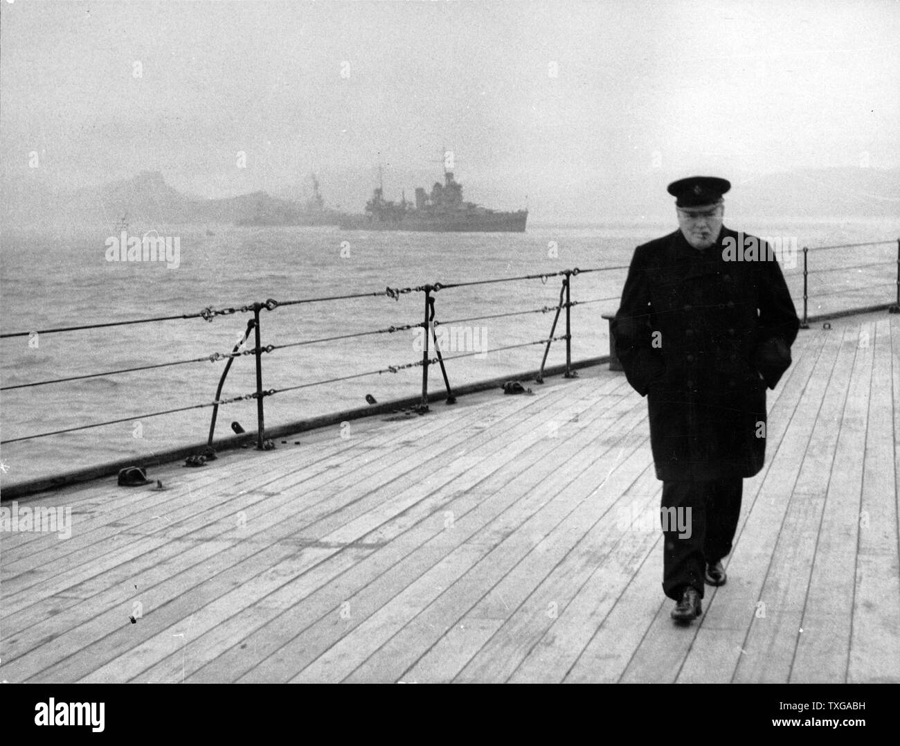 World War II (Second World War) : Winston Spencer Churchill (1874-1965) British statesman, in overcoat and hat and smoking a cigar, walking alone on the deck of HMS 'Prince of Wales' during the Atlantic Conference in 1941. Stock Photo