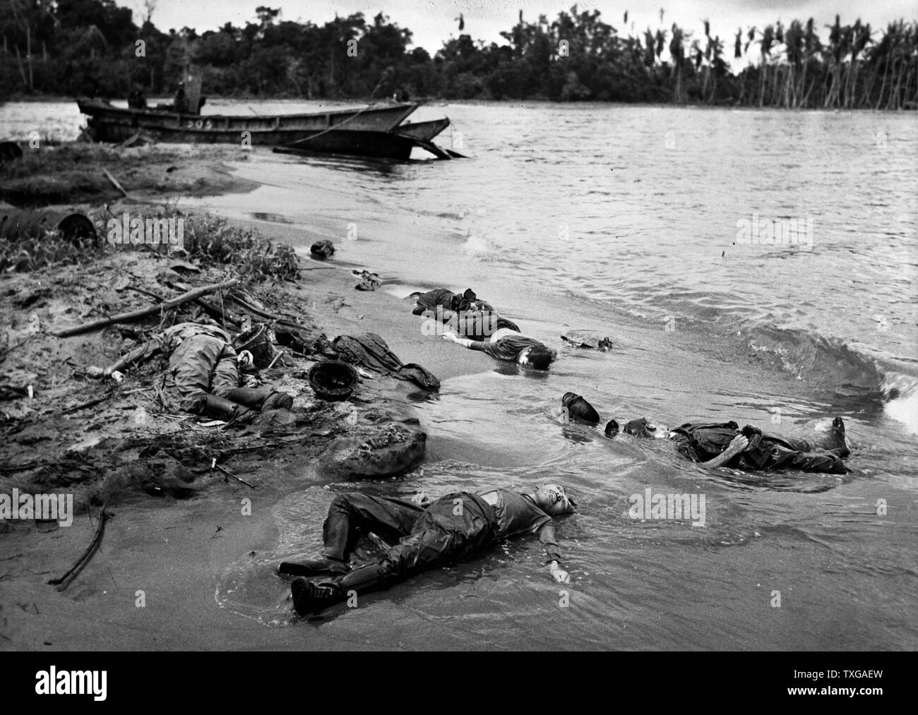 U.S. forces inflict heavy casualties on the Japanese in capture of Buna, New Guinea. On the beach of Buna Mission, last point of Japanese resistance in the Papuan section of New Guinea, the bodies of slain Japanese soldiers lie a few steps from their shattered landing boat. The Japanese suffered heavy losses in this engagement and eventually were completely routed by American and Australian forces Stock Photo