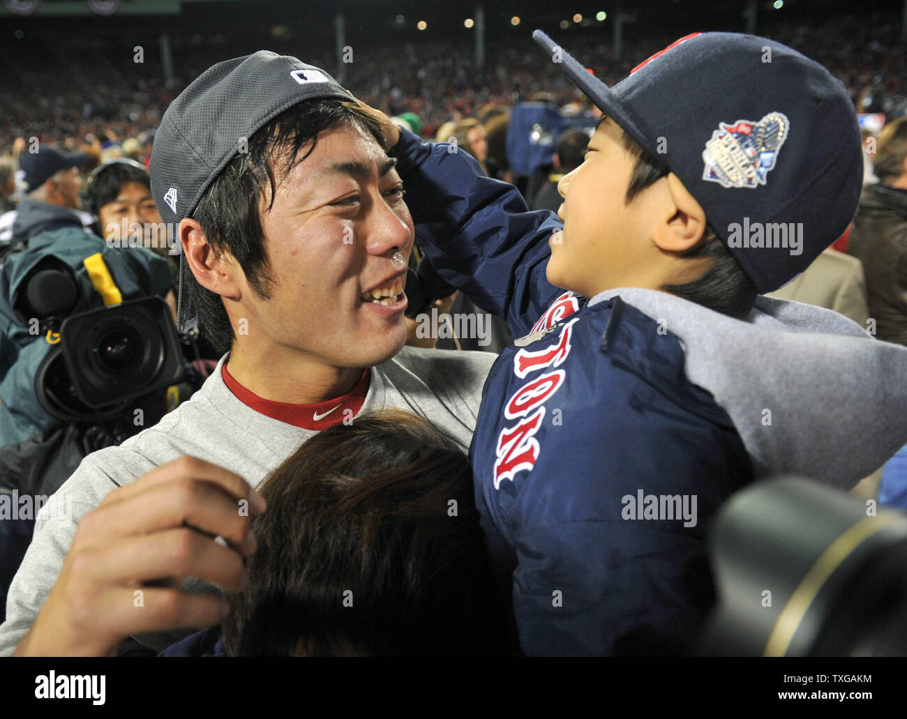 Boston Red Sox closer Koji Uehara holds his son Kazuma as they celebrate on  the field after the Red Sox won the 2013 World Series defeating the St.  Louis Cardinals in game