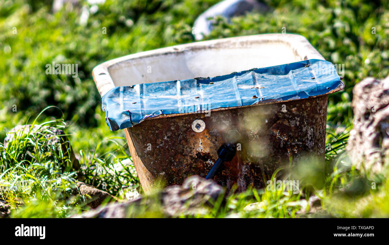Old, rusty and abandoned bathtub in the countryside near the village of
