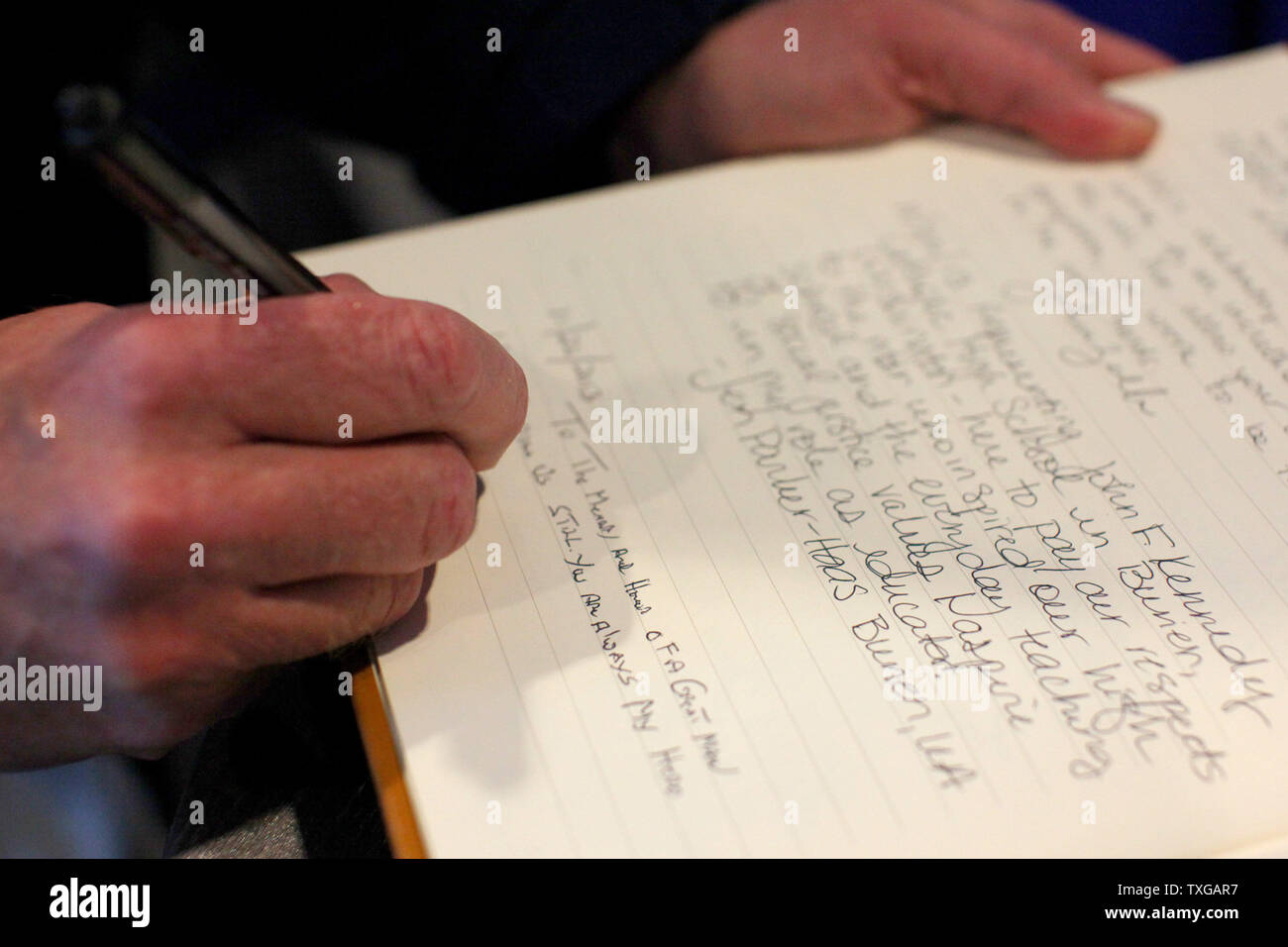 John Bates of Melrose, Massachusetts signs a memory book dedicated to President John F. Kennedy inside the John F. Kennedy Presidential Library and Museum in Boston on November 22, 2013.  Today marks the 50th Anniversary of JFK's assassination in Dallas.  UPI/Matthew Healey Stock Photo