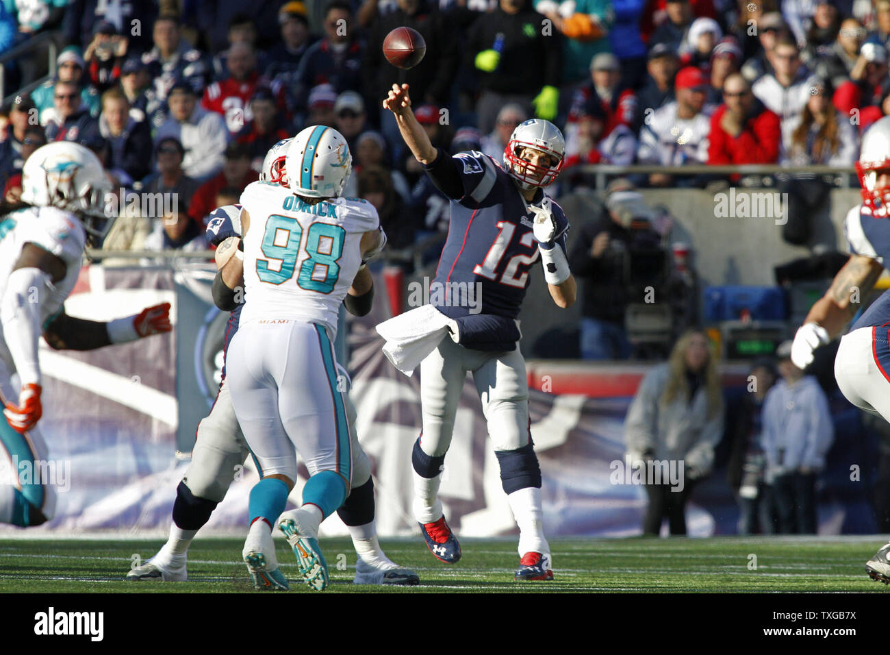 New England Patriots quarterback Tom Brady (12) throws a pass in the first quarter against the Miami Dolphins at Gillette Stadium in Foxborough, Massachusetts on December 14, 2014.   UPI/Matthew Healey Stock Photo