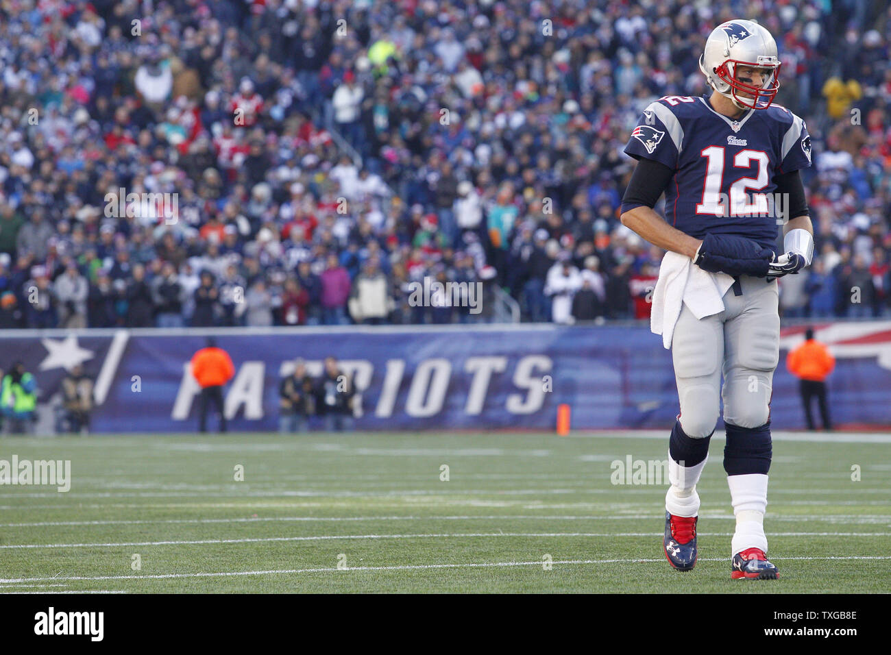 New England Patriots quarterback Tom Brady (12) walks on the field in the second quarter against the Miami Dolphins at Gillette Stadium in Foxborough, Massachusetts on December 14, 2014.  The Patriots defeated the Dolphins 41-13 and clinched the AFC East.   UPI/Matthew Healey Stock Photo