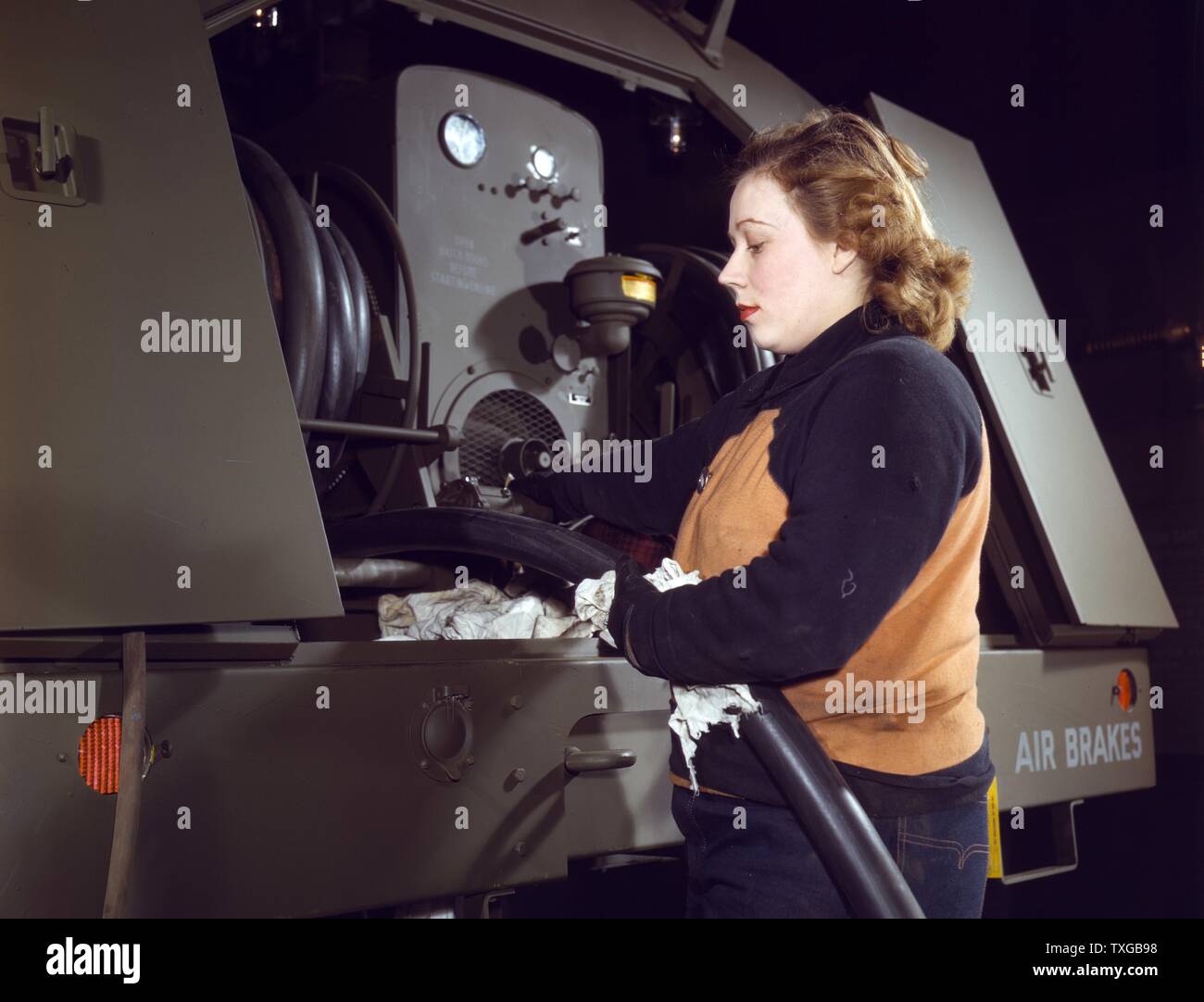 Agnes Cliemka, 23, Milwaukee, Wisconsin, checking the gasoline hose of gasoline trailers before giving them to the Air Force Stock Photo
