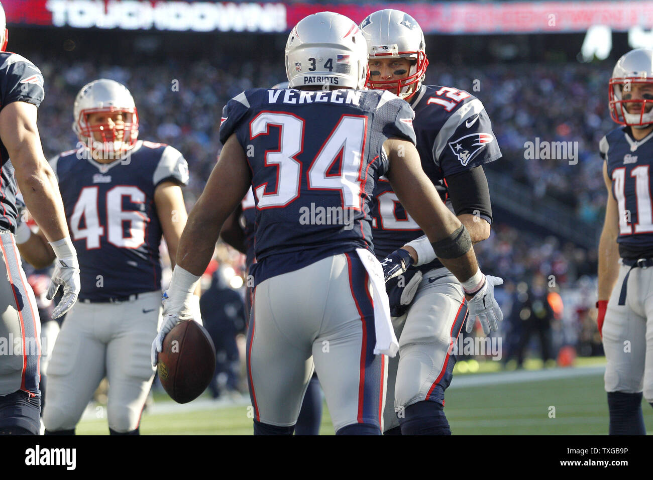 New England Patriots running back Shane Vereen (34) is congratulated by quarterback Tom Brady (12) after his three-yard touchdown carry in the second quarter against the Miami Dolphins at Gillette Stadium in Foxborough, Massachusetts on December 14, 2014.   UPI/Matthew Healey Stock Photo