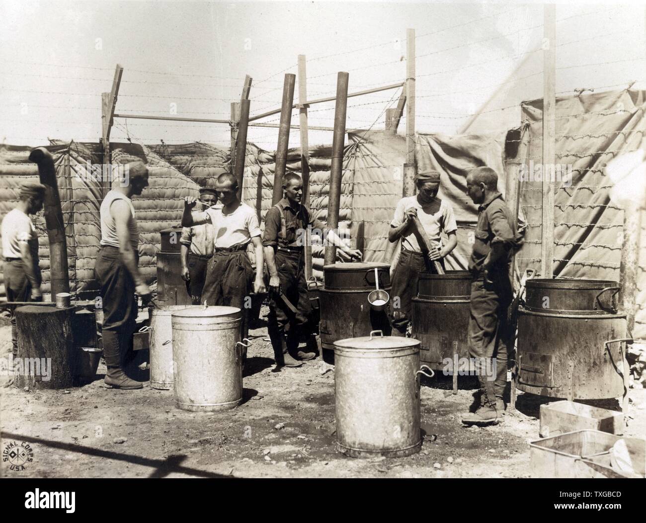 The open air kitchen used by German prisoners while a new mess hall and kitchen is being erected Camp Miramas, near Marseilles, France. Photograph shows German prisoners of war cooking in large pots in outdoor kitchen. Stock Photo