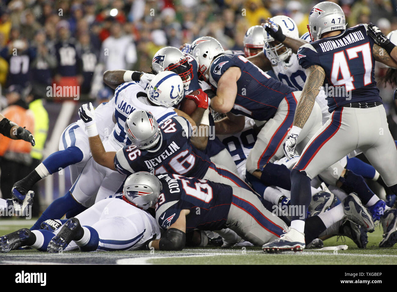 New England Patriots running back LeGarrette Blount (29) is congratulated  by offensive lineman Dan Connolly (63) after a two-yard touchdown carry in  a rainy fourth quarter of the AFC Championship Game at