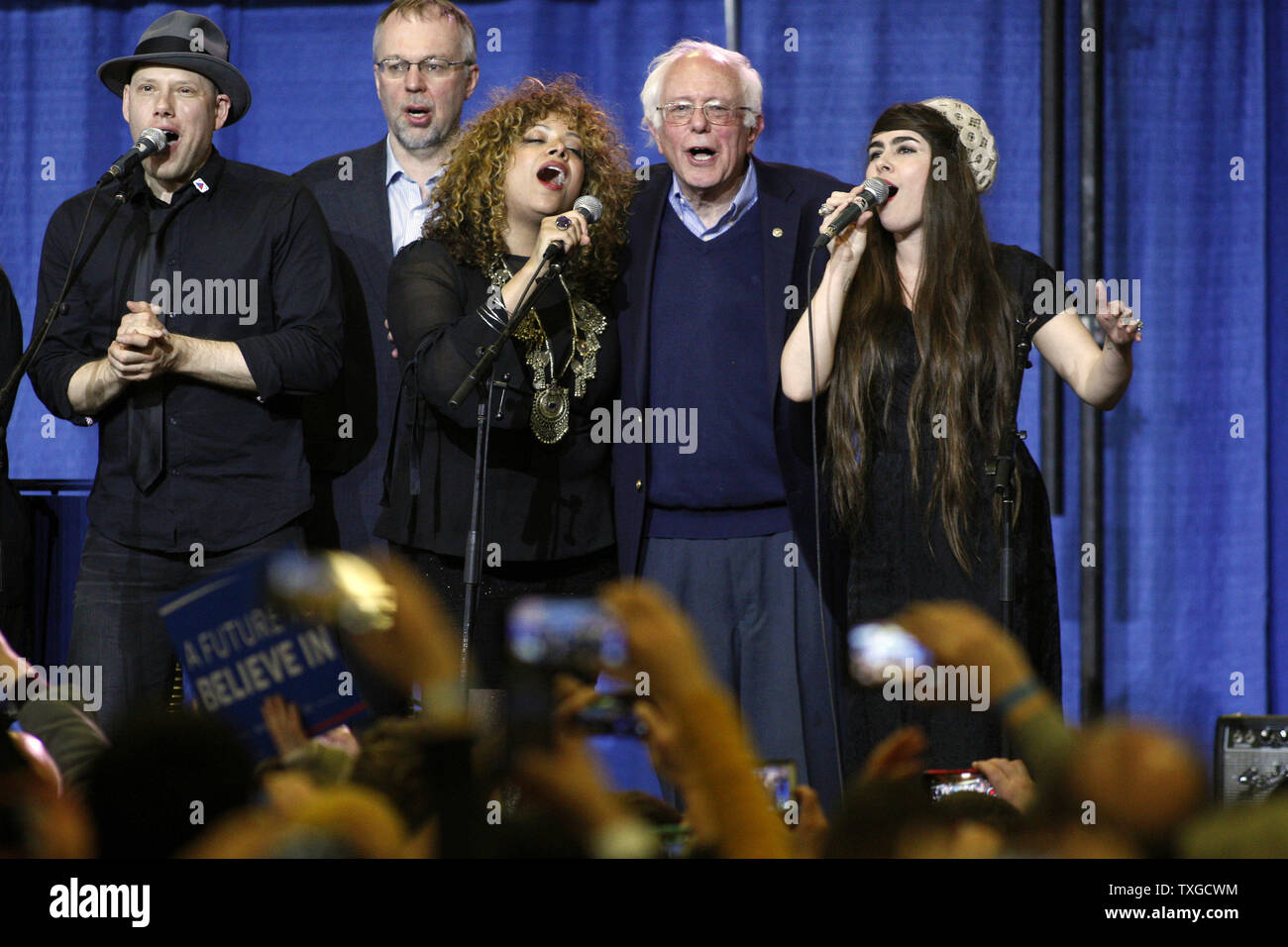 Democratic Presidential candidate Bernie Sanders (2nd-L) sings along as the house band plays the Woody Guthrie song 'This Land is Your Land' at a Super Tuesday rally at the Champlain Valley Exposition in Essex Junction, Vermont on March 1, 2016.   Photo by Matthew Healey/UPI Stock Photo