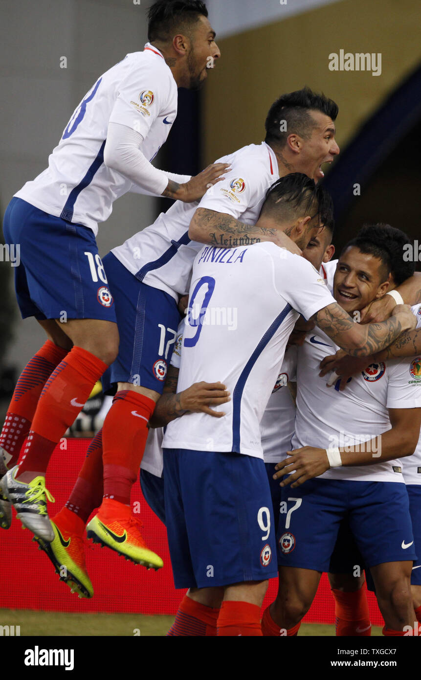 Chile players from left defender Gonzalo Jara (18), defender Gary Medal (17), forward Maurico Pinilla (9) and forward Alexis Sanchez (7) surround midfielder Arturo Vidal after Vidal scored in the second half of the Copa America Centenario Group D match against Bolivia at Gillette Stadium in Foxboro, Massachusetts on on June 10, 2016. Chile defeated Bolivia 2-1.  Photo by Matthew Healey/UPI Stock Photo