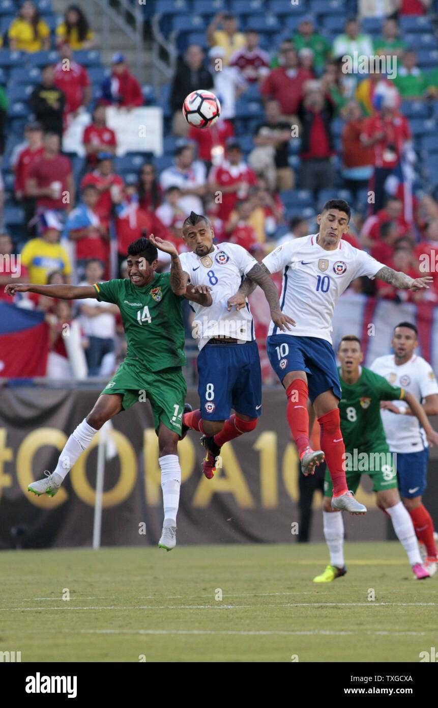 Bolivia forward Raul Castro (14) Chile midfielders Arturo Vidal (8) and  Pedro Pablo Hernandez (10) all jump up for a header in the first half of the Copa America Centenario Group D match at Gillette Stadium in Foxboro, Massachusetts on on June 10, 2016.  Photo by Matthew Healey/UPI Stock Photo