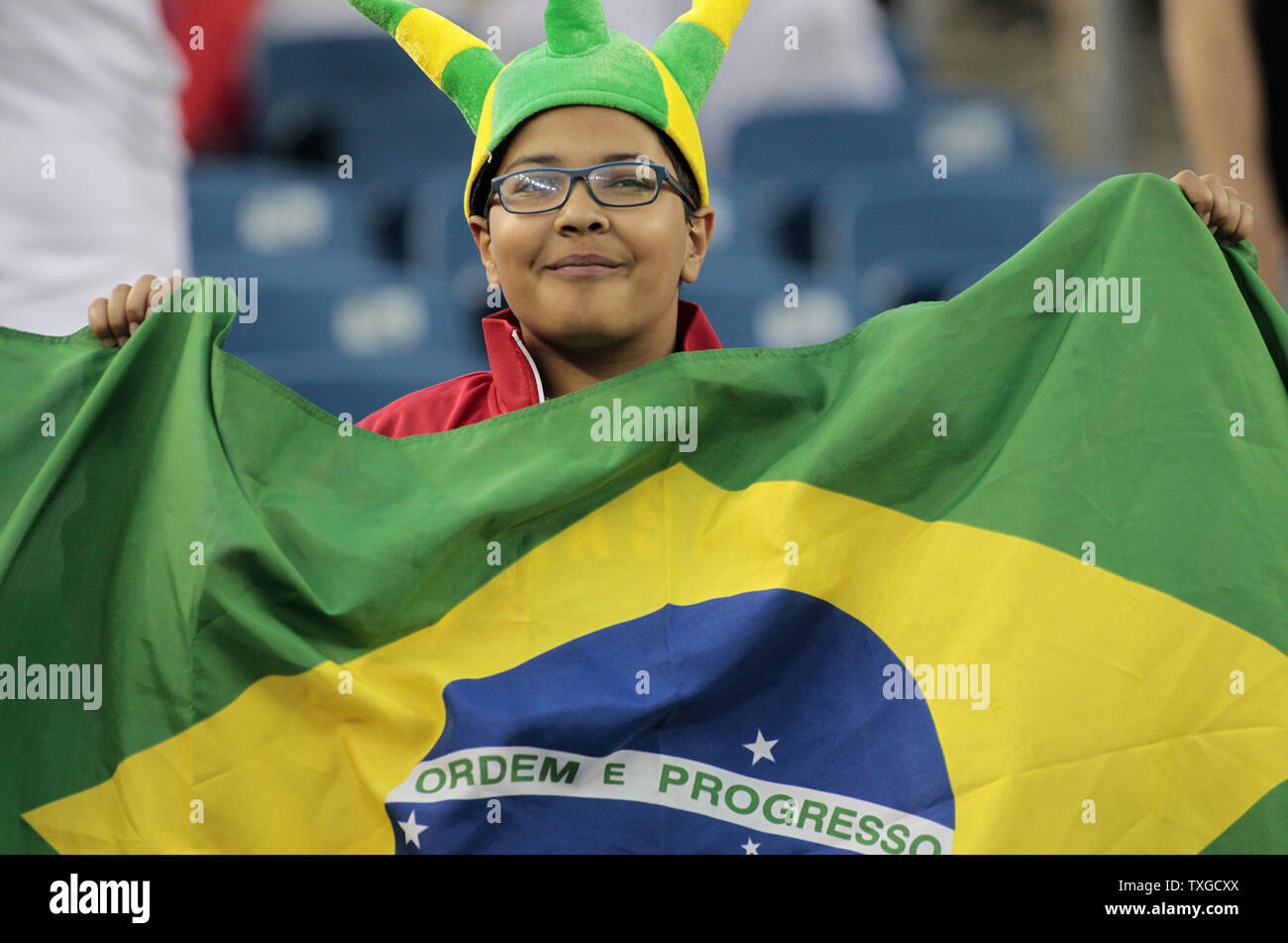 A young Brazil soccer fan waves a Brazilian flag prior to the 2016 Copa America Centenario Group B match against Peru at Gillette Stadium in Foxborough, Massachusetts on June 12, 2016.  Photo by Matthew Healey/UPI Stock Photo