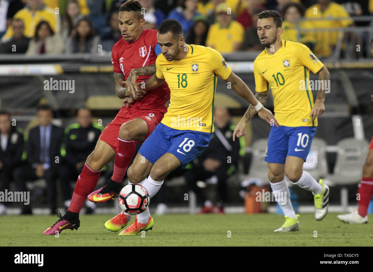 Peru forward Jose Guerrero (9) and Brazil midfielder Renato Augusto (18) tangle with each other while going for the ball during the first half of the 2016 Copa America Centenario Group B match at Gillette Stadium in Foxborough, Massachusetts on June 12, 2016.  Photo by Matthew Healey/UPI Stock Photo