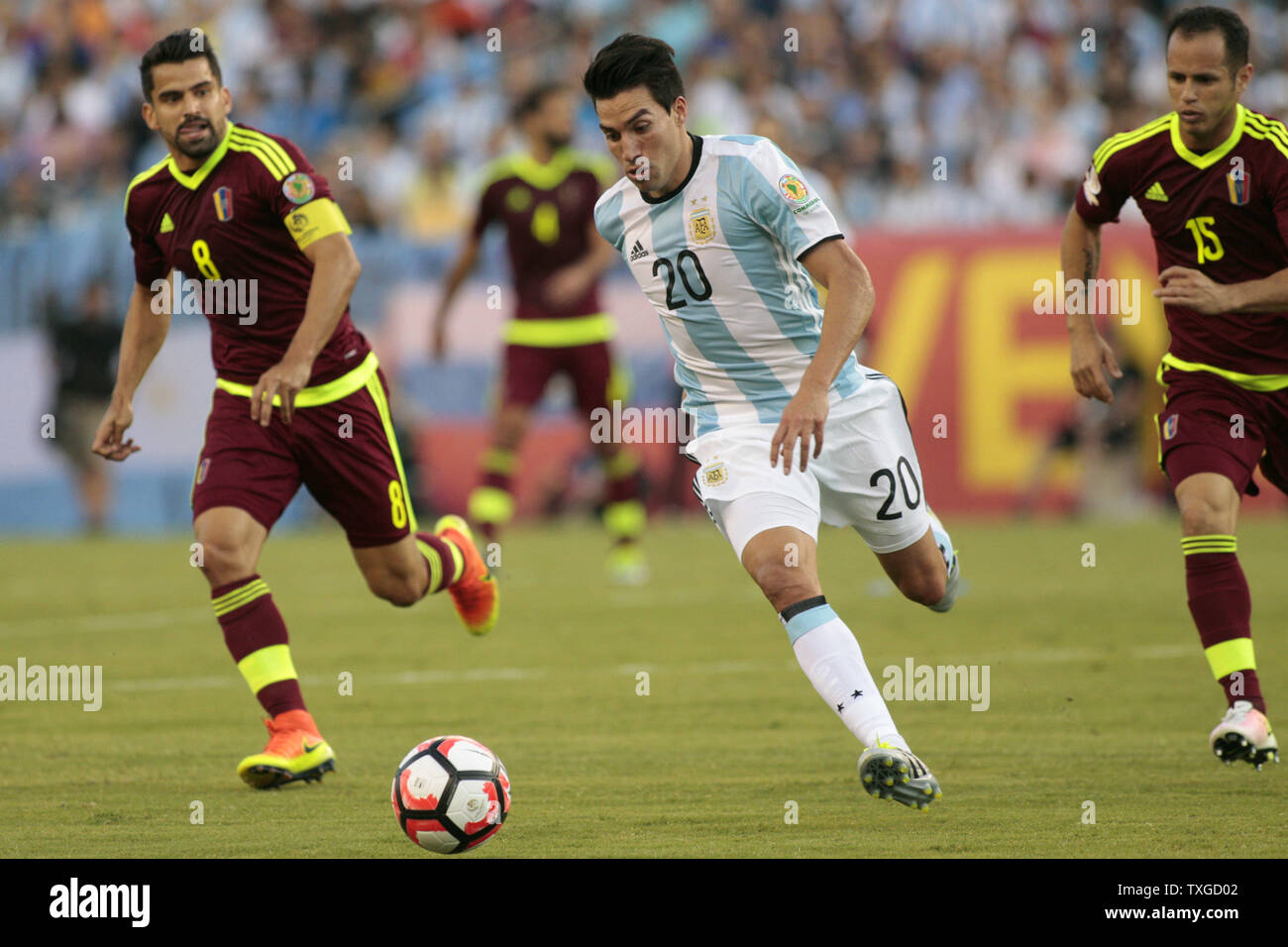 Argentina forward Nicolas Gaitan (20) charges down field as Venezuela midfielders Tomas Rincon (8) and Alejandro Guerra (15) give chase in the first half of the 2016 Copa America Centenario quarterfinal match at Gillette Stadium in Foxborough, Massachusetts on June 18, 2016. Argentina defeated Venezuela 4-1. Photo by Matthew Healey/UPI Stock Photo