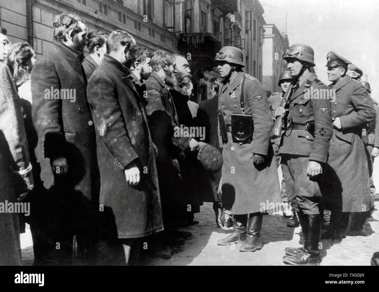 Photograph from Nowolipie Street with Josef Blösche (1912-1969) member of the National Socialist German Workers Party, stopping Jewish Rabbis. Dated 1940 Stock Photo