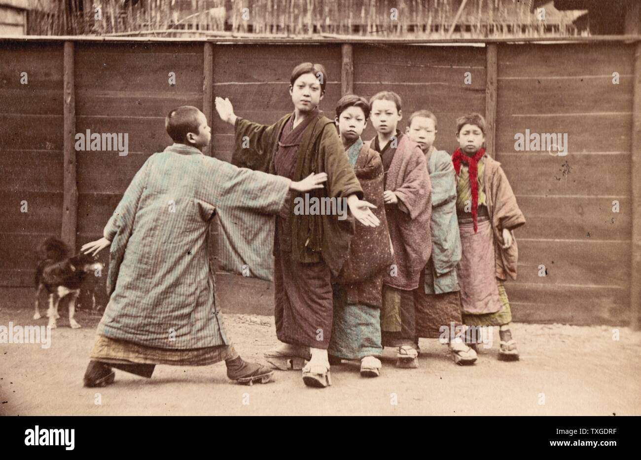 Hand-coloured photograph of Japanese boys playing by Felice Beato (1832-1909) Italian-British photographer. Dated 1890 Stock Photo