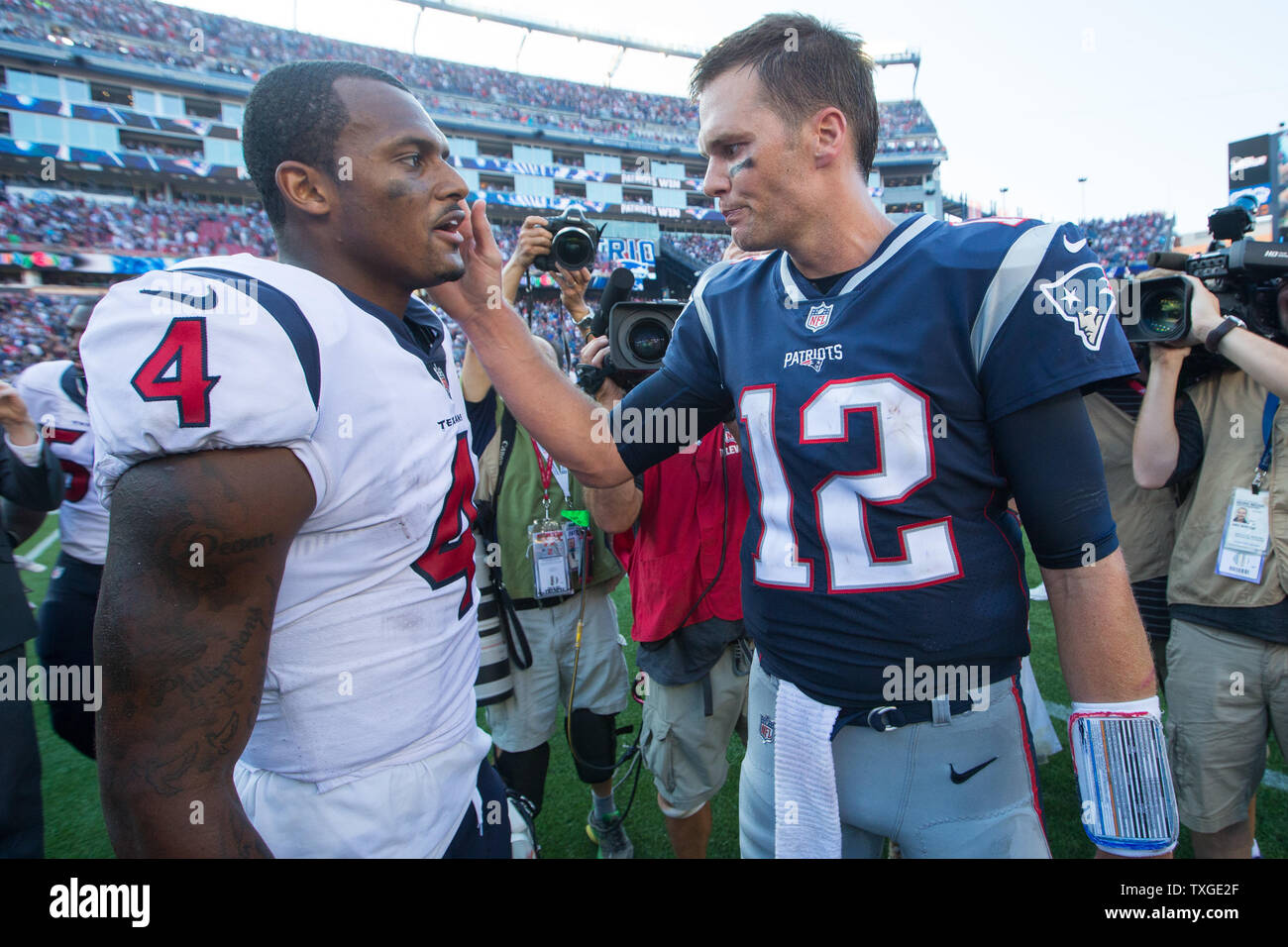 New England Patriots quarterback Tom Brady (12) gives Houston Texans quarterback Deshaun Watson (4) a pat on the cheek after their game at Gillette Stadium in Foxborough, Massachusetts on September 24, 2017. The Patriots defeated the Texans 36-33.   Photo by Matthew Healey/ UPI Stock Photo