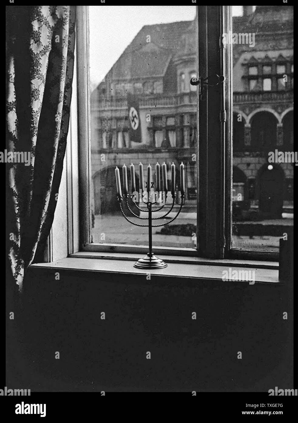Photograph of a Jewish menorah on a window ledge in Nazi Germany. Dated