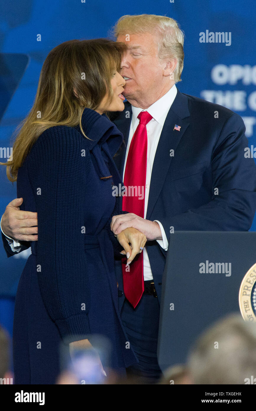 First Lady of the United States Melania Trump (L) gets a kiss from her  husband, United States President Donald Trump, at a speech announcing his  administration's plan to combat the opioid crisis