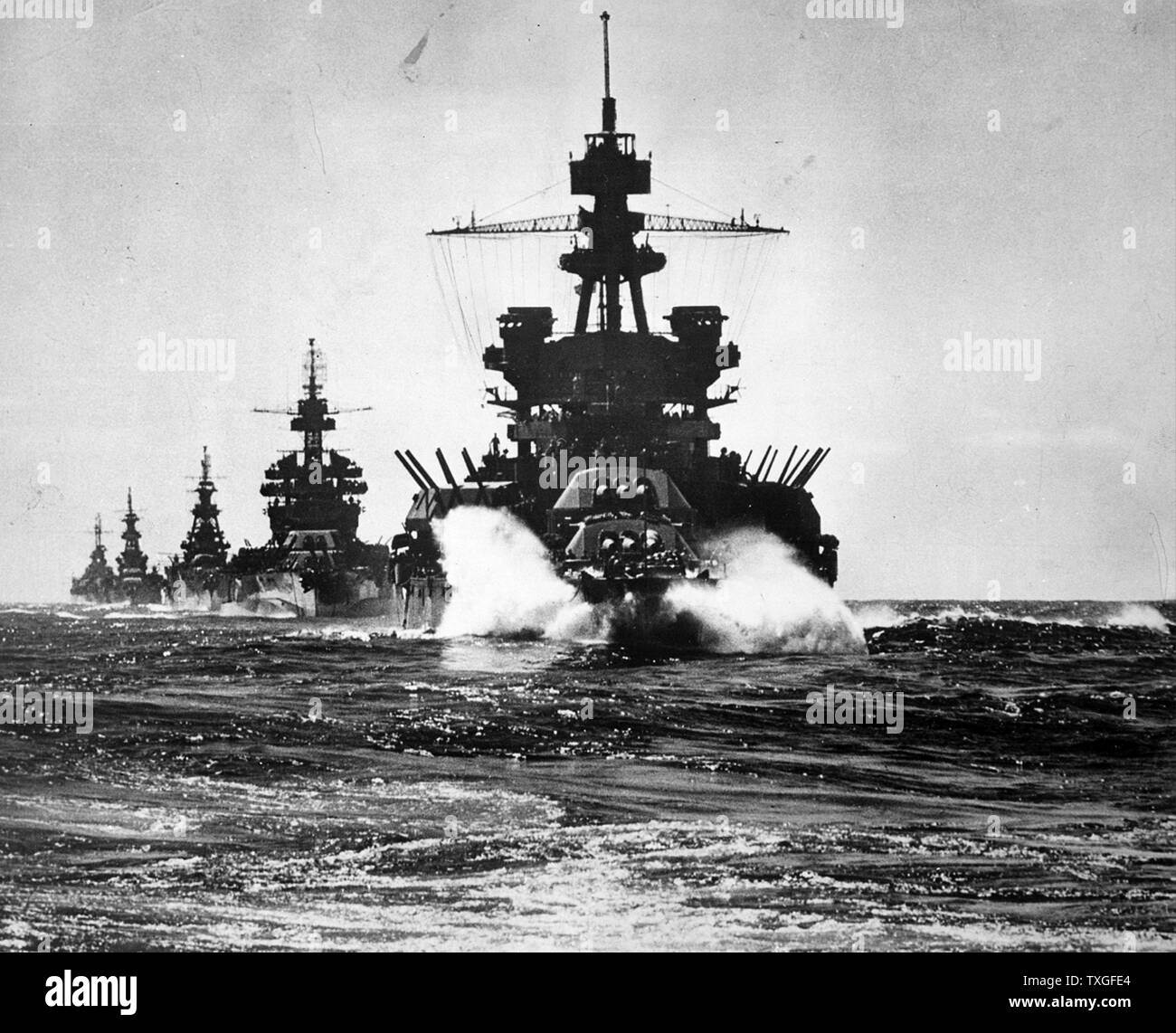 USS Pennsylvania followed by three cruisers move into Lingayen Gulf in the Philippines, during World War two. 1945 Stock Photo