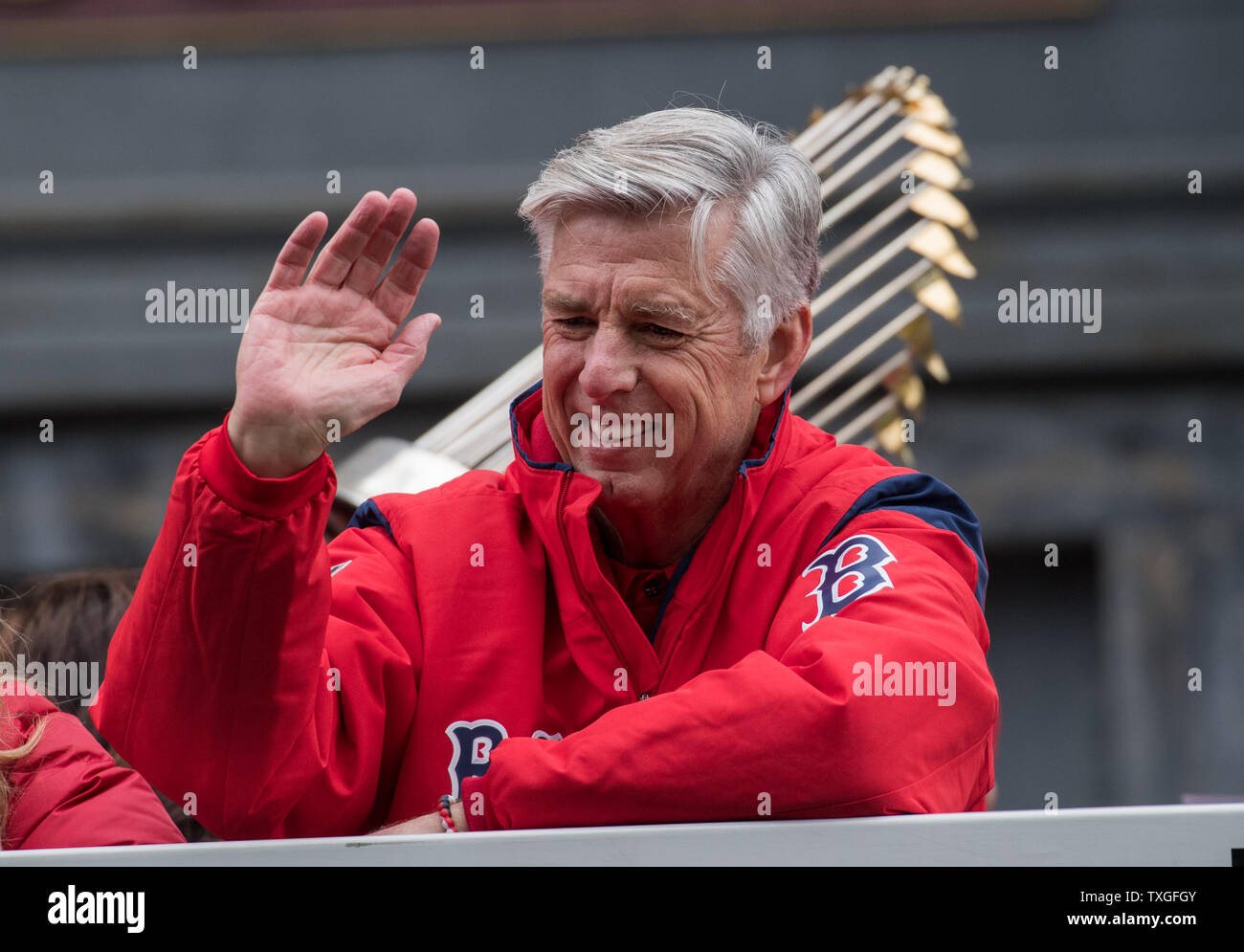 Boston red sox general manager waves to the crowds during the duck boat