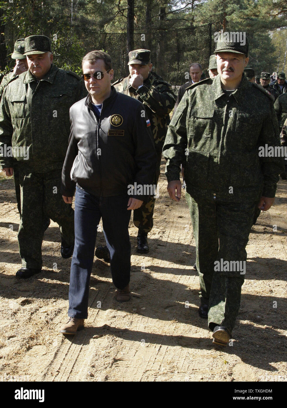 Russian President Dmitry Medvedev (C) and Belorussian President Alexander Lukashenko (R) walk during the final stage of Zapad-2009 (West 2009) Russian-Belarus joint military exercises at at Obuz-Lesnovsky training range near Brest in western Belarus on September 29, 2009. UPI/Anatoli Zhdanov Stock Photo