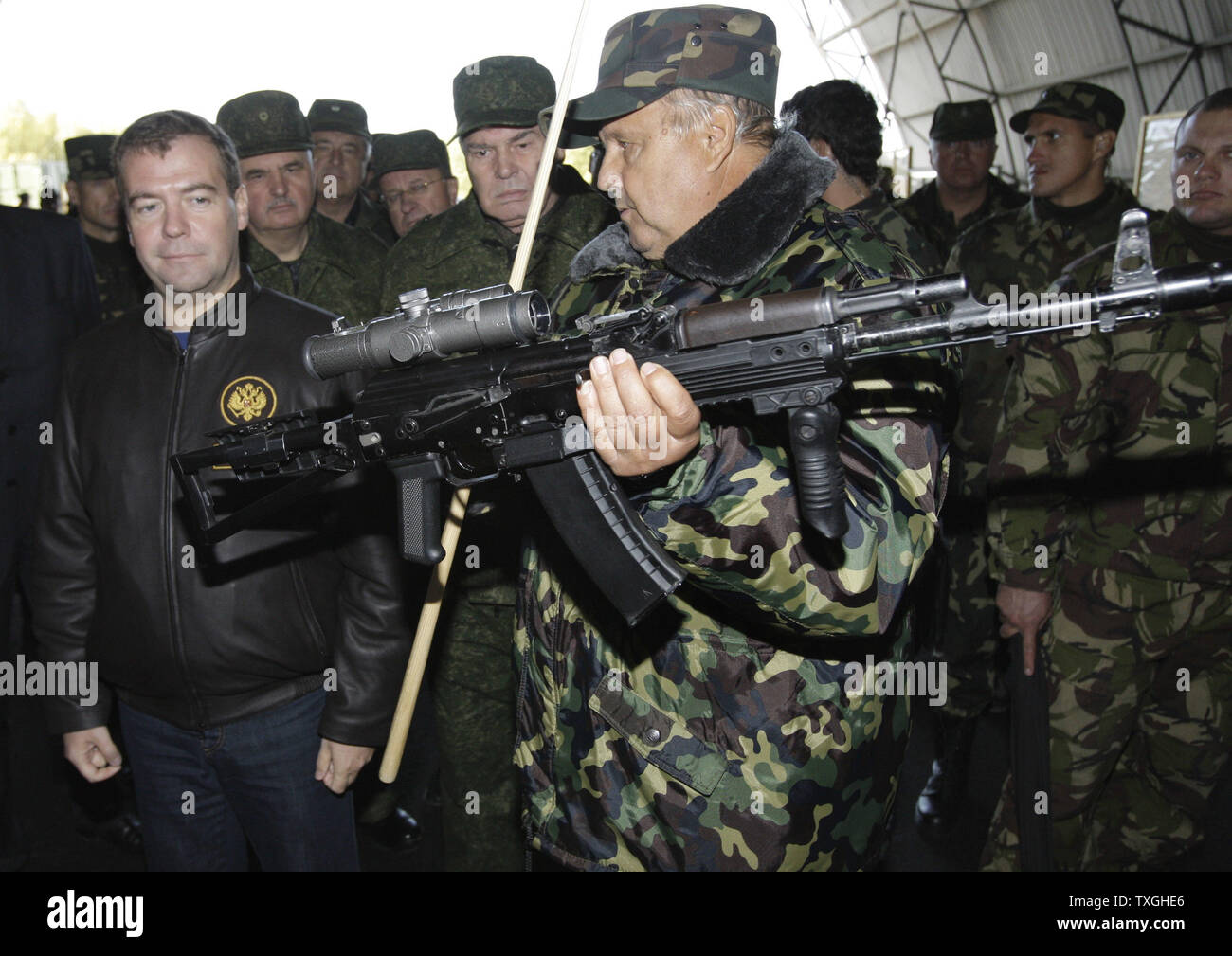 Russian President Dmitry Medvedev (L) looks at Kalashnikov automatic weapon with a sniper sight as he attends the final stage of Zapad-2009 (West 2009) Russian-Belarus joint military exercises near Brest in western Belarus on September 29, 2009. UPI/Anatoli Zhdanov Stock Photo