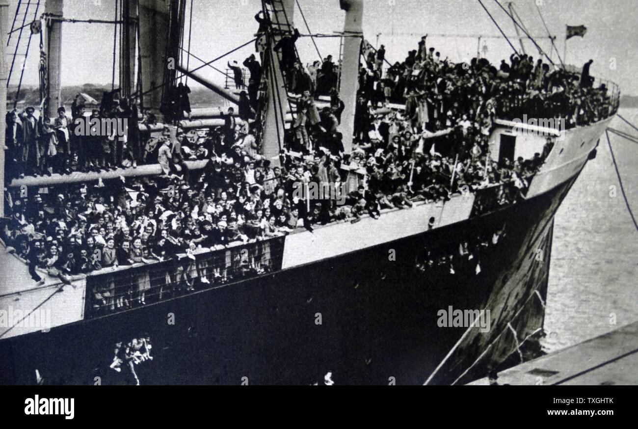 Photographic print showing women and children aboard a boat taking them away from the regions where General Franco's conquests brought war. Dated 20th Century Stock Photo