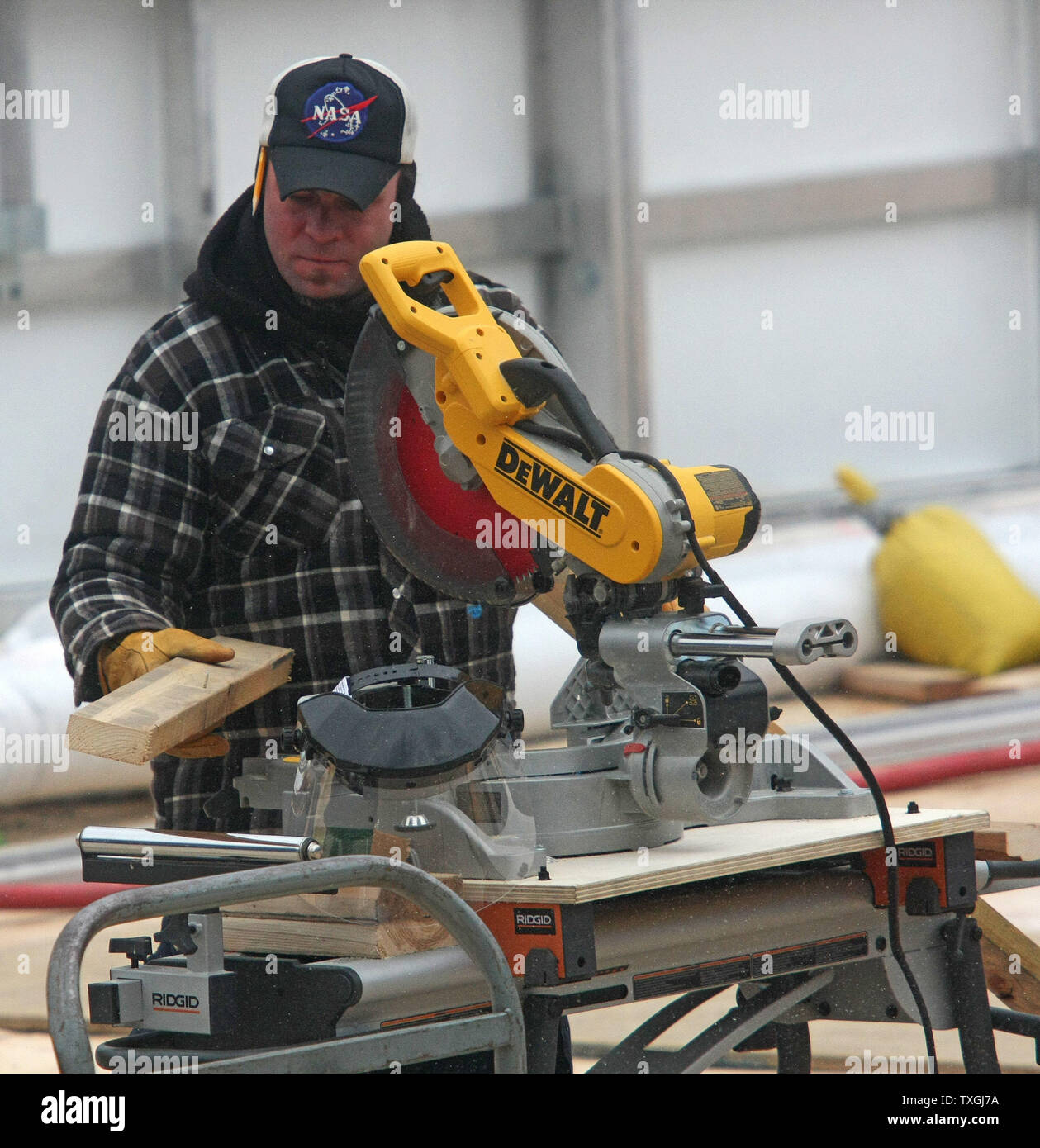 A worker cuts a piece of wood in preparation for the 2008 NHL Winter Classic to be played on January 1, 2008 at Ralph Wilson Stadium in Orchard Park, New York on December 29, 2007. (UPI Photo/Jerome Davis). Stock Photo