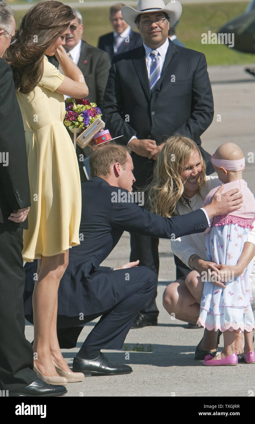 On the final leg of their royal tour, Kate watches her husband Prince  William comfort cancer patient and flower girl Diamond Marshall during the  Duke and Duchess of Cambridge's arrival by military