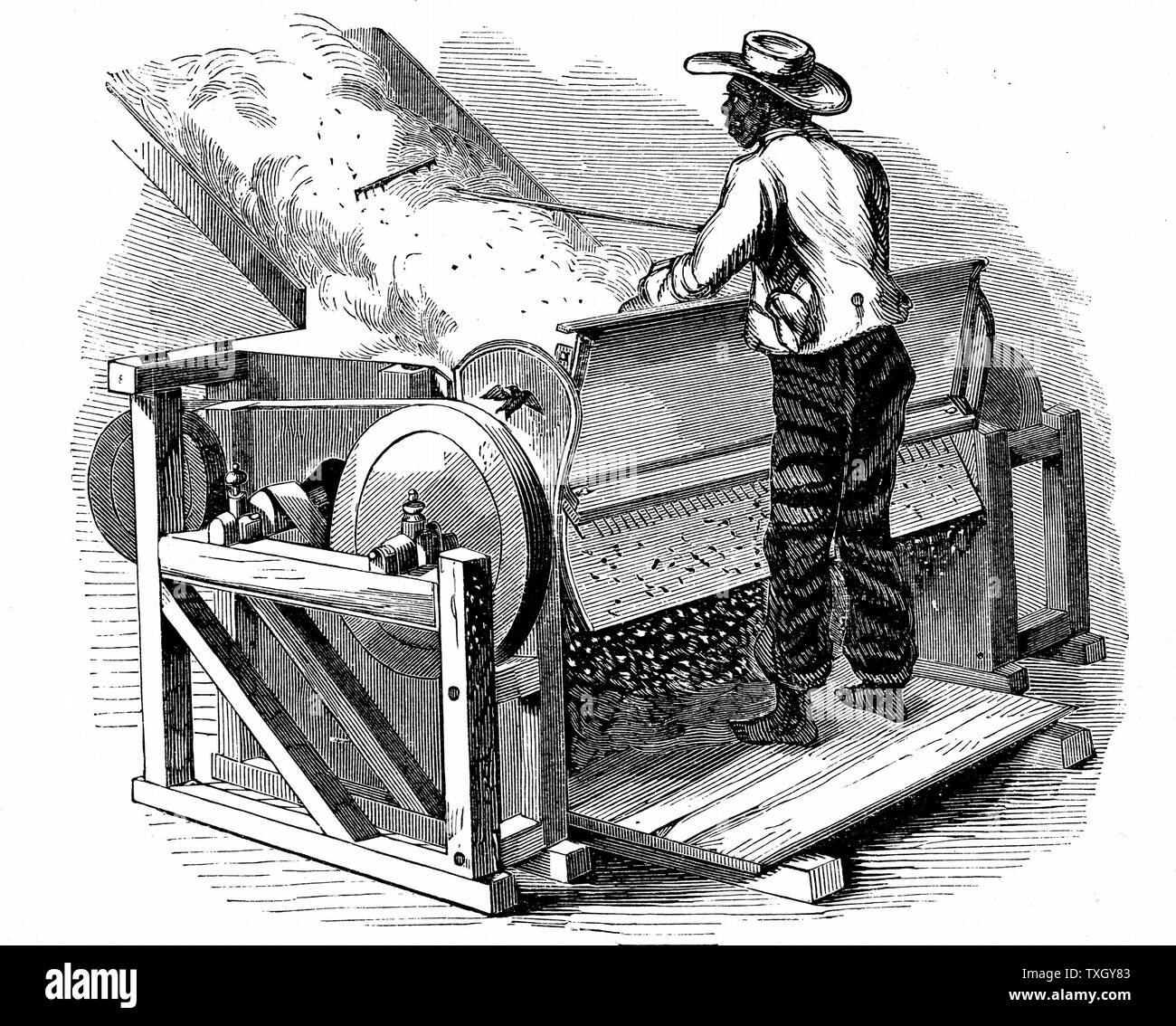 Saw gin for cleaning cotton being operated by barefoot black labourer Southern States of USA Eagle gin, improved form of Whitney gin 1865 Wood engraving Stock Photo