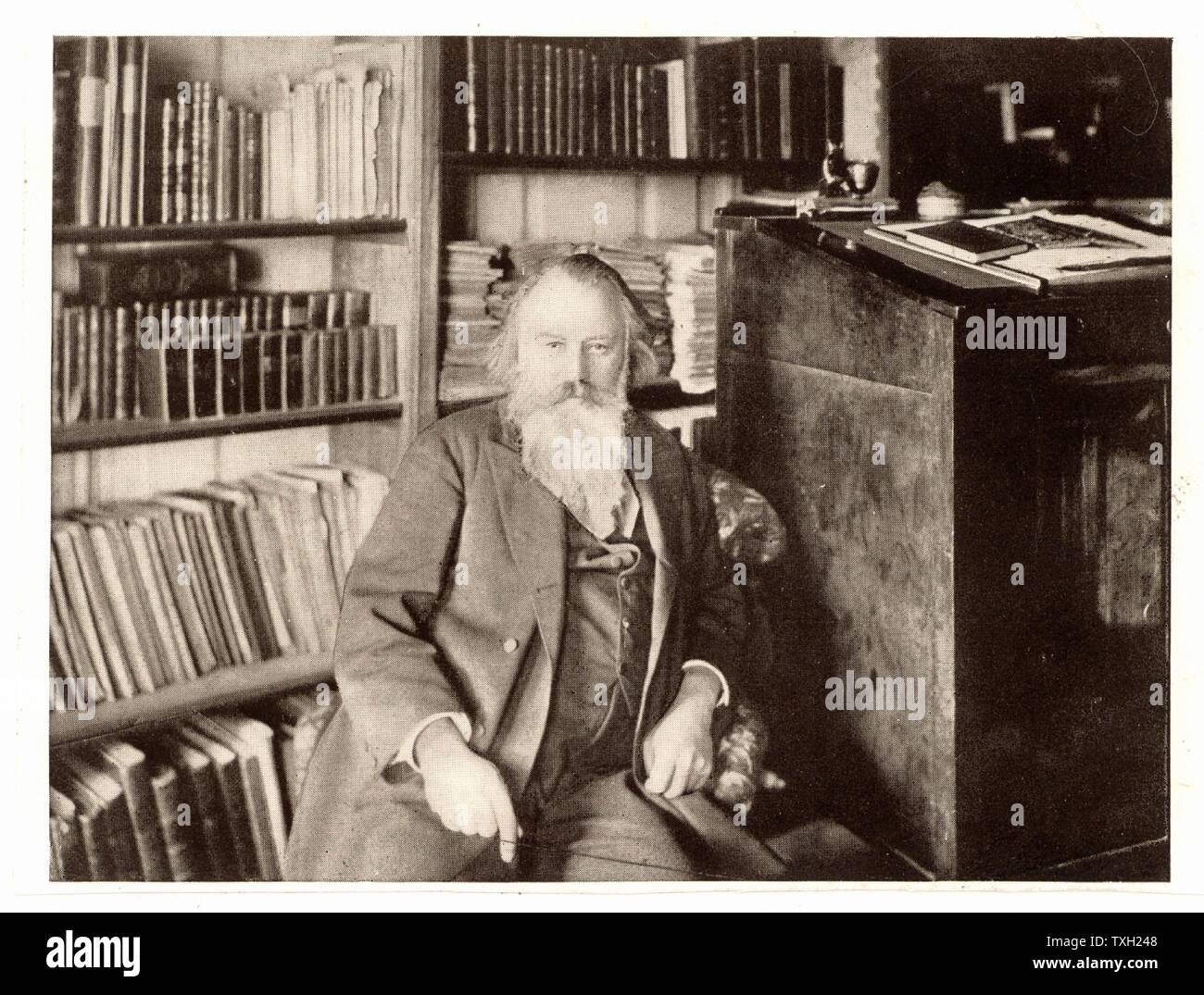 Johannes Brahms (1833-1897) German composer, in his library.  From a photograph. Halftone. Music. Stock Photo