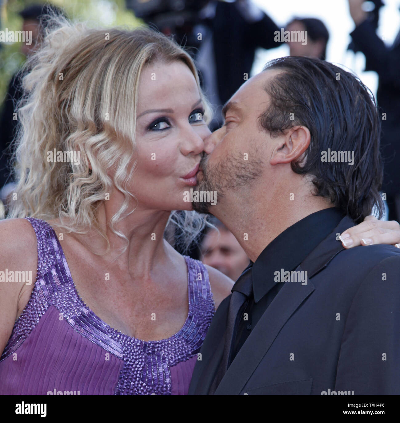 Henri Leconte and wife Florentine share a kiss on the red carpet before