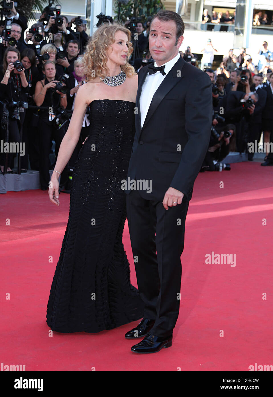 Jean Dujardin (R) and his wife Alexandra Lamy arrive on the red carpet  before the screening of the film "The Artist" during the 64th annual Cannes  International Film Festival in Cannes, France