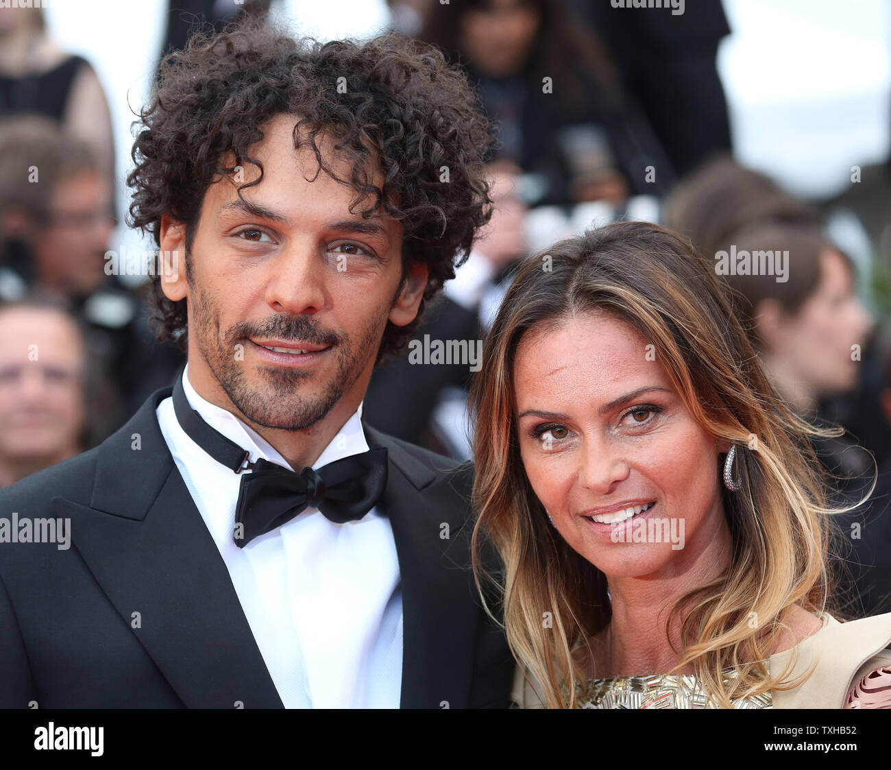 Tomer Sisley (L) and his partner Julie arrive on the red carpet before the  screening of the film "Inside Llewyn Davis" during the 66th annual Cannes  International Film Festival in Cannes, France