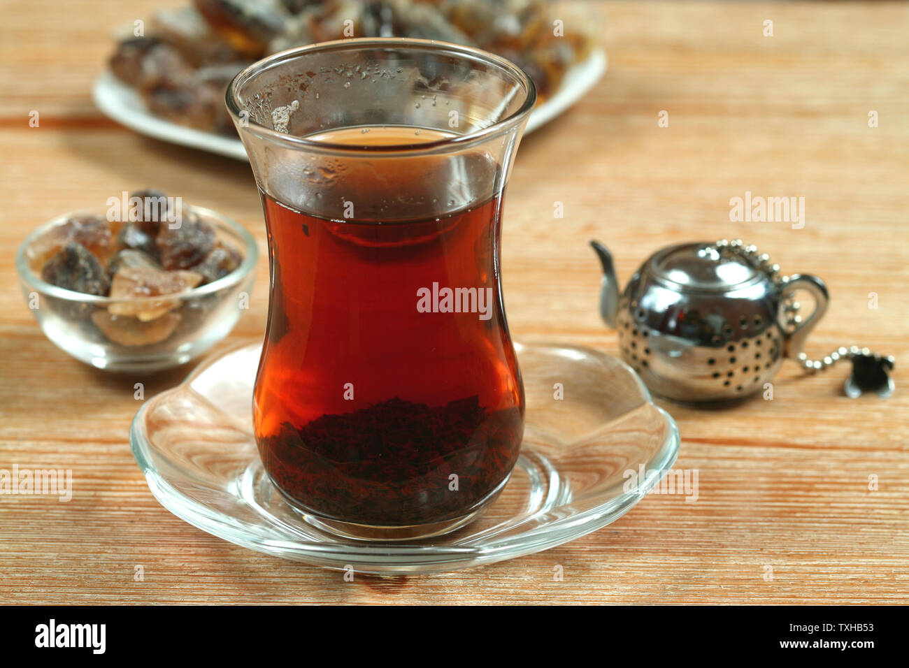 Tea prepared in turkish way, cane sugar and small steel teapot. Five o