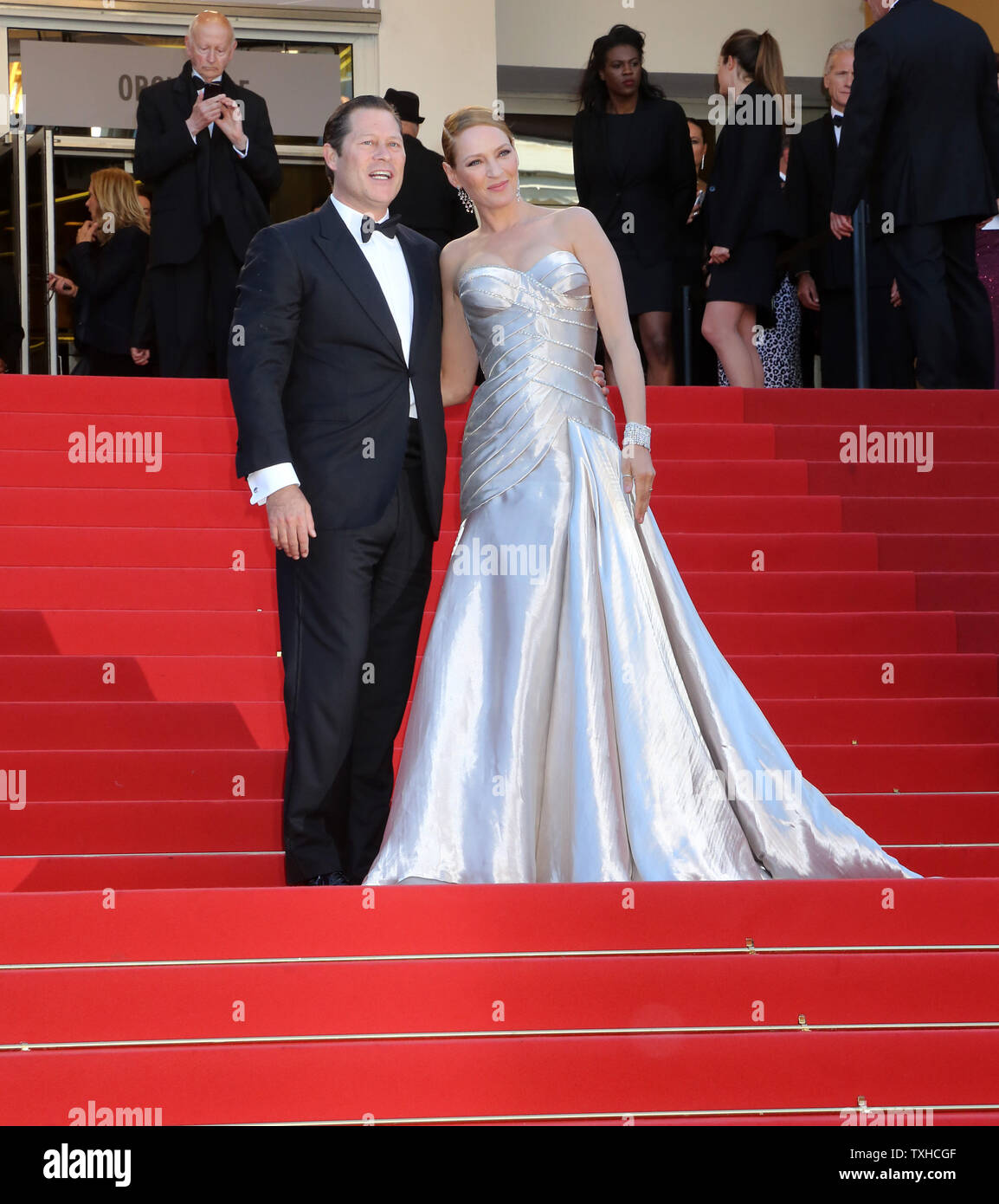 Uma Thurman (R) and Arpad Busson arrive on the red carpet before the screening of the film 'Zulu' during the 66th annual Cannes International Film Festival in Cannes, France on May 26, 2013.  UPI/David Silpa Stock Photo