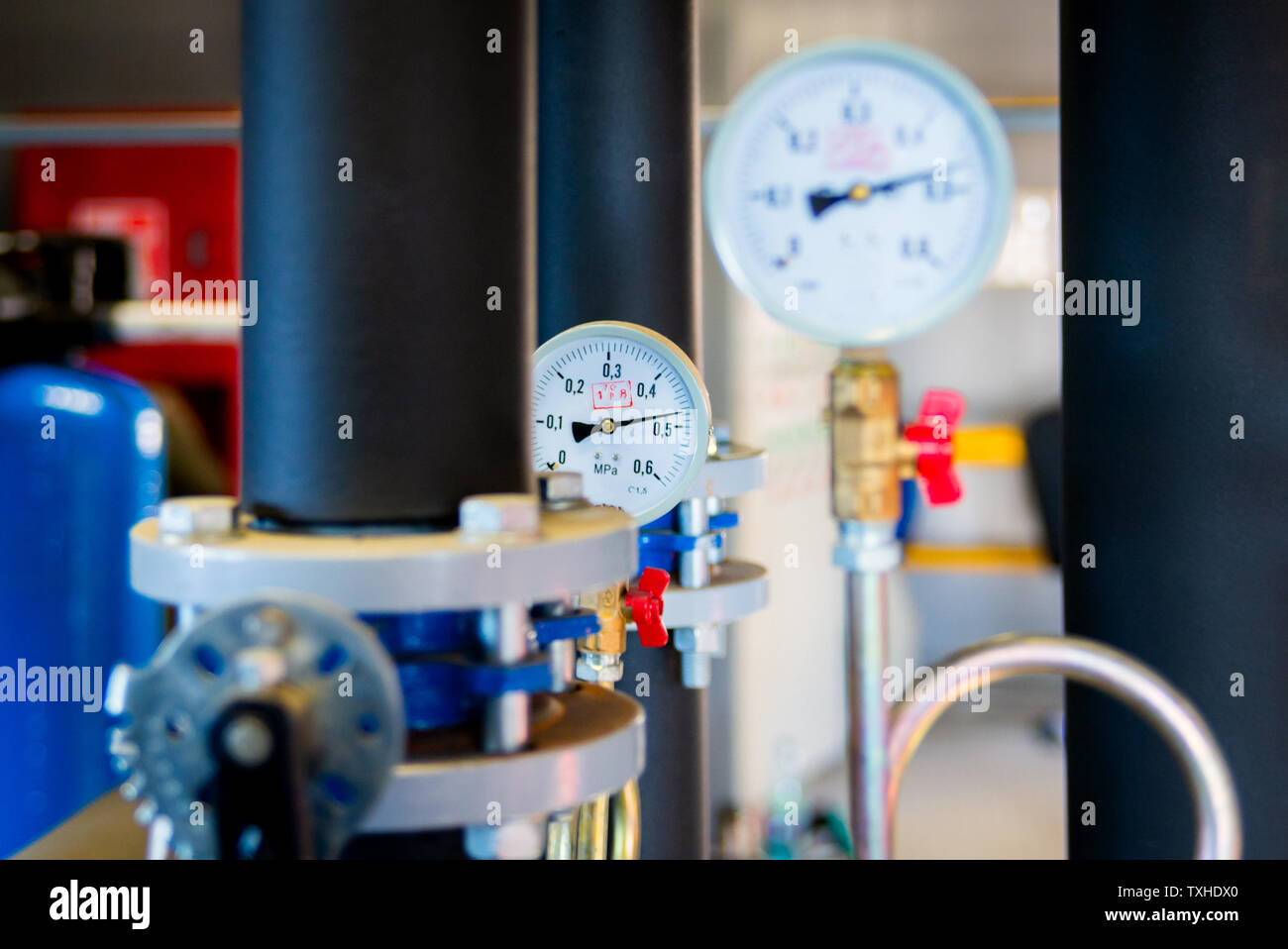 Closeup of manometer, measuring gas pressure. Pipes and valves at
