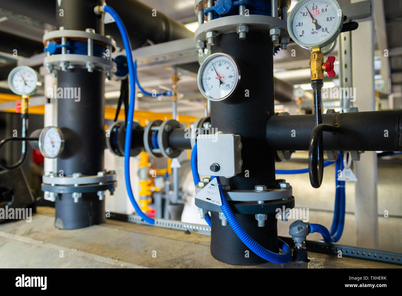 The equipment of the boilerhouse, valves, tubes, pressure gauges, thermometer. Close up of