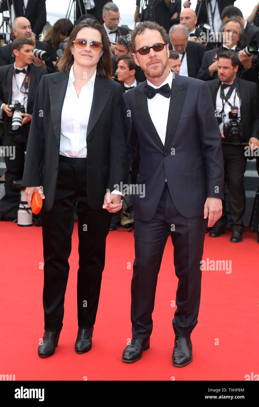 Tricia Cooke (L) and Ethan Coen arrive on the red carpet before the ...