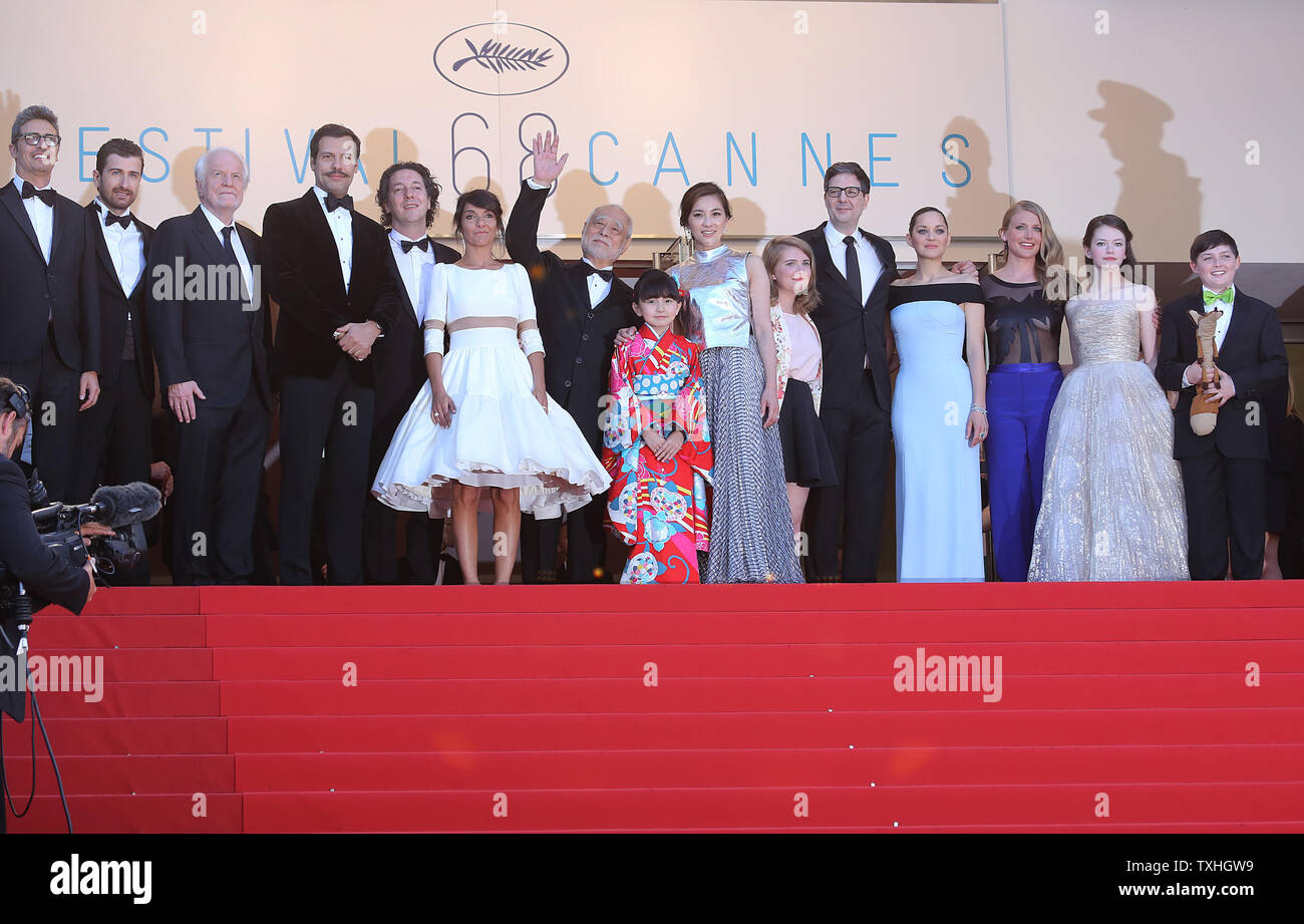 The team from the film "The Little Prince", including Andre Dussollier, Guillaume Gallienne, Florence Foresti, Laurent Lafitte, Clara Poincare, Masahiko Tsugawa, Rio Suzuki, Asaka Seto, Marion Cotillard, Riley Osborne, Charlotte Vandermeersch, Mark Osborne and Mackenzie Foy, arrive on the steps of the Palais des Festivals before the screening of their film during the 68th annual Cannes International Film Festival in Cannes, France on May 22, 2015.  Photo by David Silpa/UPI.. Stock Photo