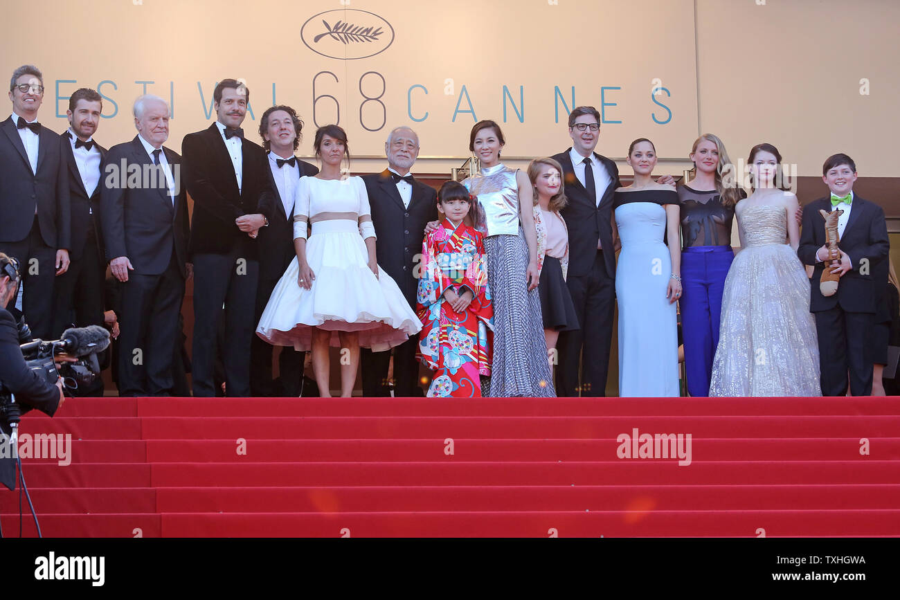 The team from the film 'The Little Prince', including Andre Dussollier, Guillaume Gallienne, Florence Foresti, Laurent Lafitte, Clara Poincare, Masahiko Tsugawa, Rio Suzuki, Asaka Seto, Marion Cotillard, Riley Osborne, Charlotte Vandermeersch, Mark Osborne and Mackenzie Foy, arrive on the steps of the Palais des Festivals before the screening of their film during the 68th annual Cannes International Film Festival in Cannes, France on May 22, 2015.  Photo by David Silpa/UPI.. Stock Photo
