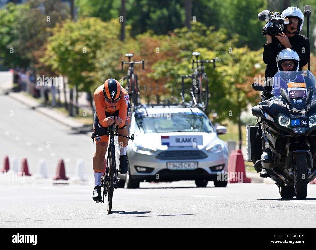 Minsk. Belarus. 25 June 2019. Chantal Blaak (NED) is followed by her car and the TV motorbike in the cycling time trial at the 2nd European games. Credit: Sport In Pictures/Alamy Live News Stock Photo