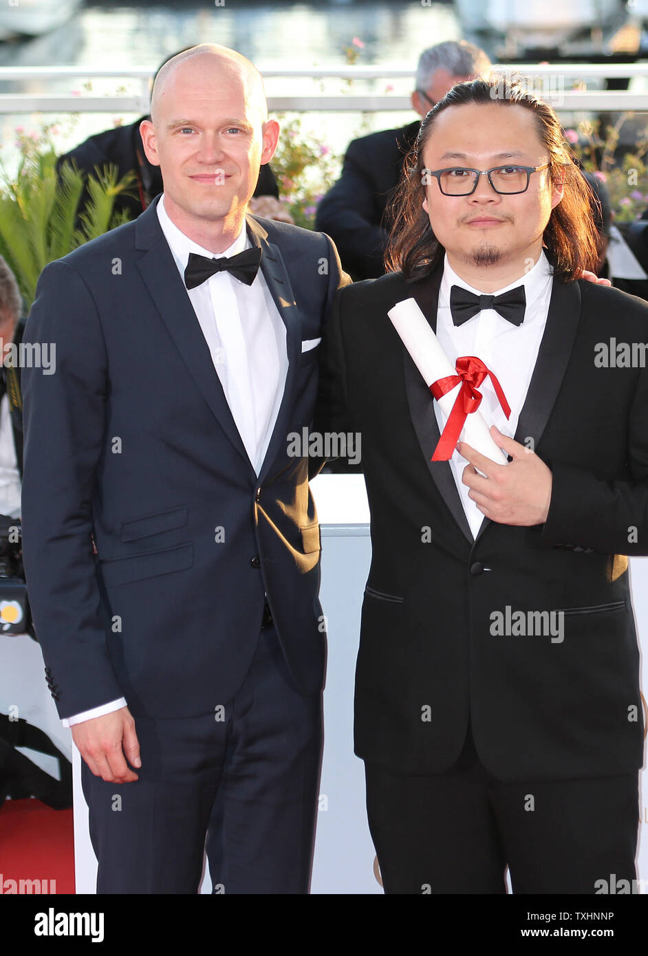 Teppo Airaksinen (L) and Qiu Yang arrive at the award photocall after  receiving the "Special Mention" and "Best Short Film" prizes (respectively)  for their films "The Ceiling" and "A Gentle Night" during
