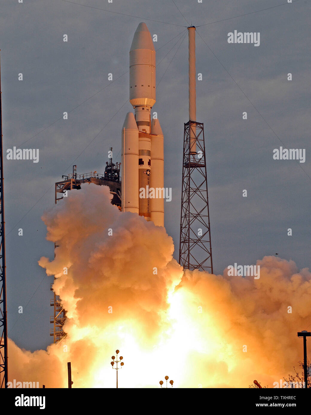 A Titan IV B rocket launches at 1:50 PM under cloudy skies from the ...