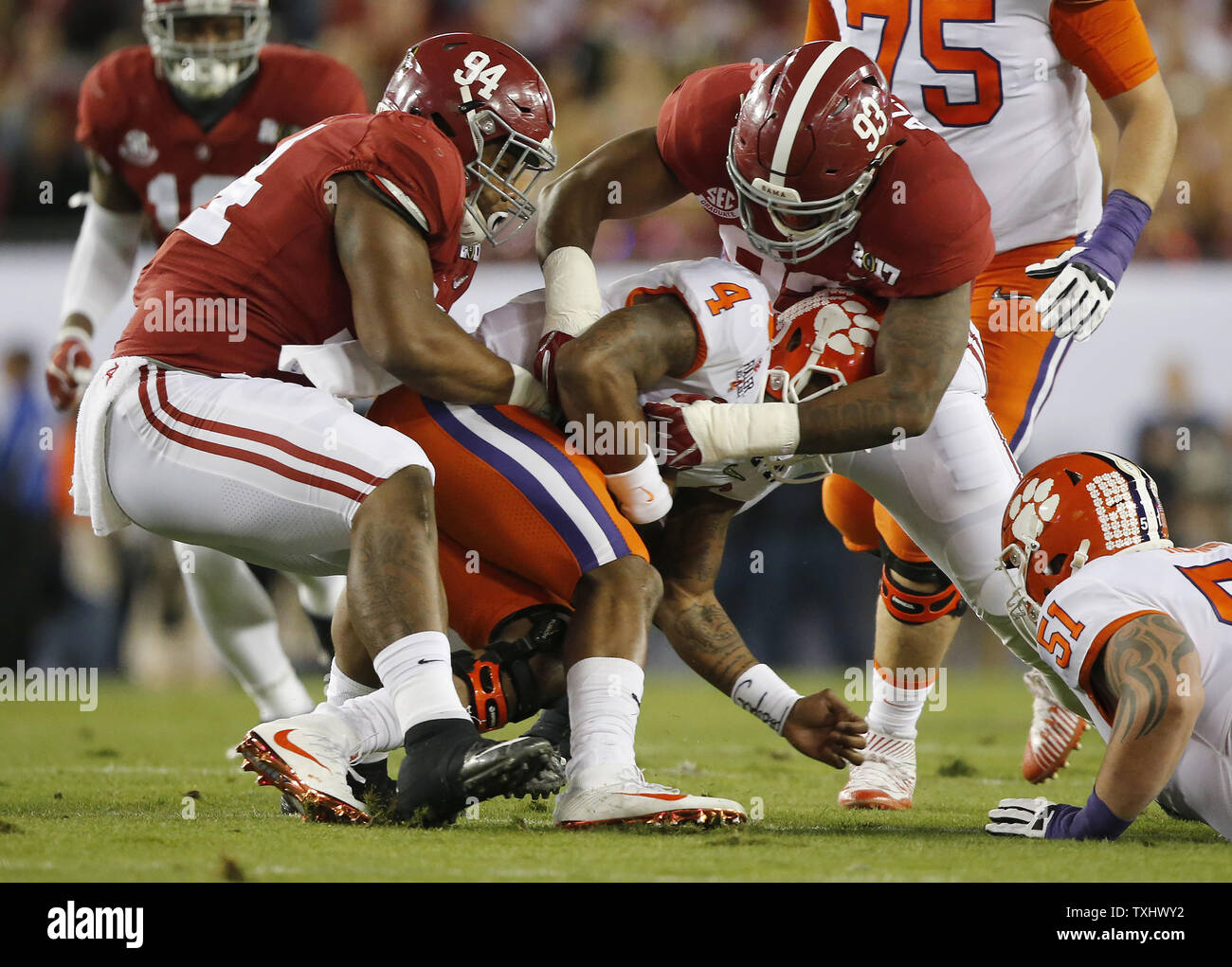 Clemson Tigers quarterback Deshaun Watson (4) is smothered on a sack by Alabama Crimson Tide defensive linemean Da'Ron Payne (94) and Jonathan Allen (93) in the first quarter of the 2017 College Football Playoff National Championship, in Tampa, Florida, on January 9, 2017. Photo by Mark Wallheiser/UPI Stock Photo