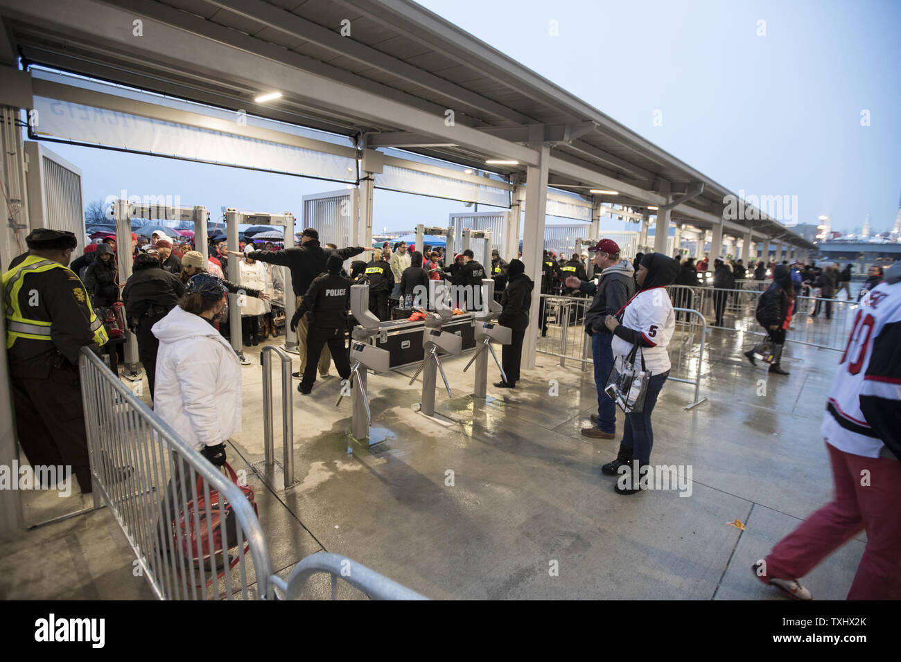 Fans Pass Through The Security Check Point As They Arrive For The Ncaa College Football Playoff Fans Pass Through The Security Check Point As They Arrive For The Ncaa College Football Playoff