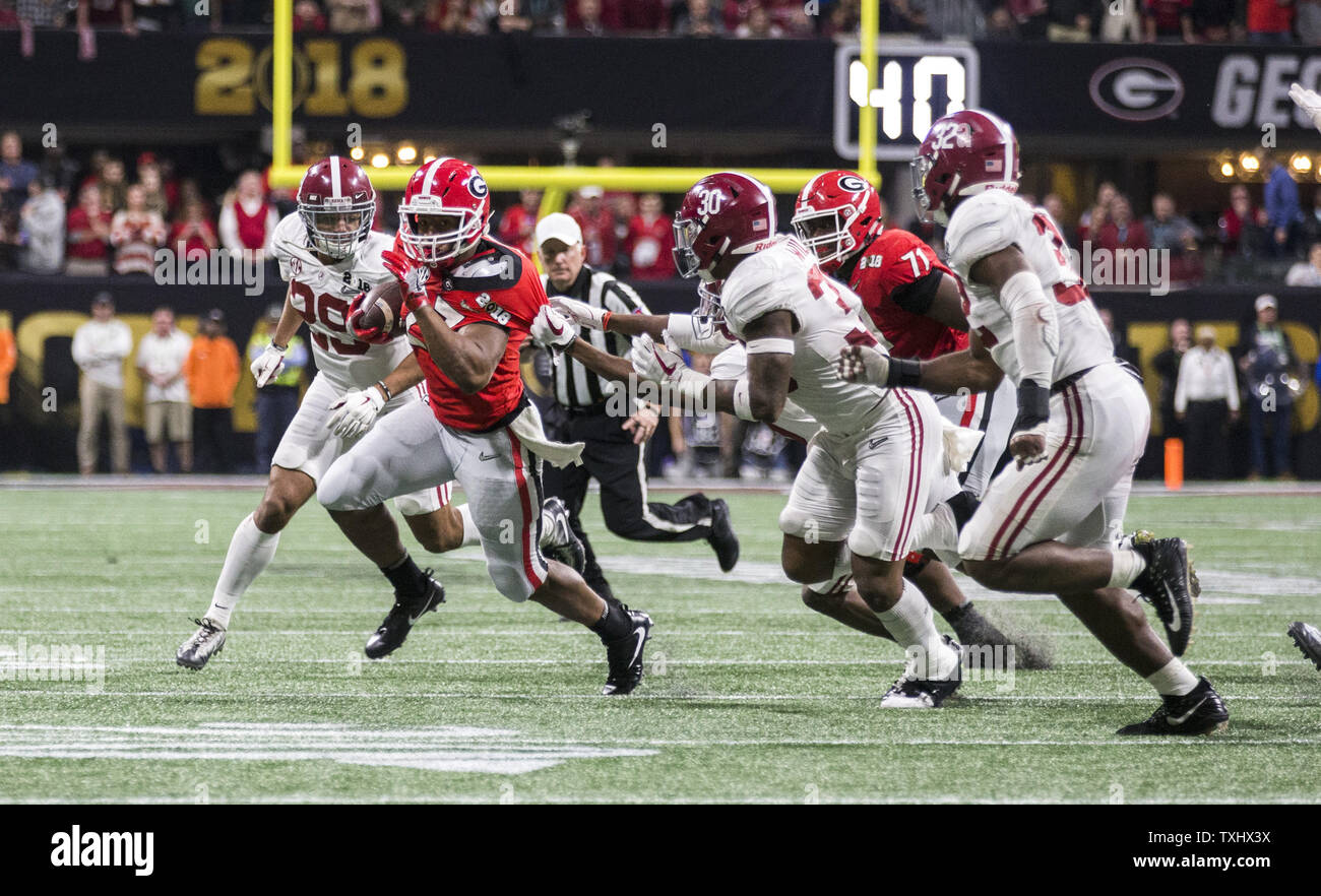 Bulldogs running back Nick Chubb (27) is pursued by the Alabama