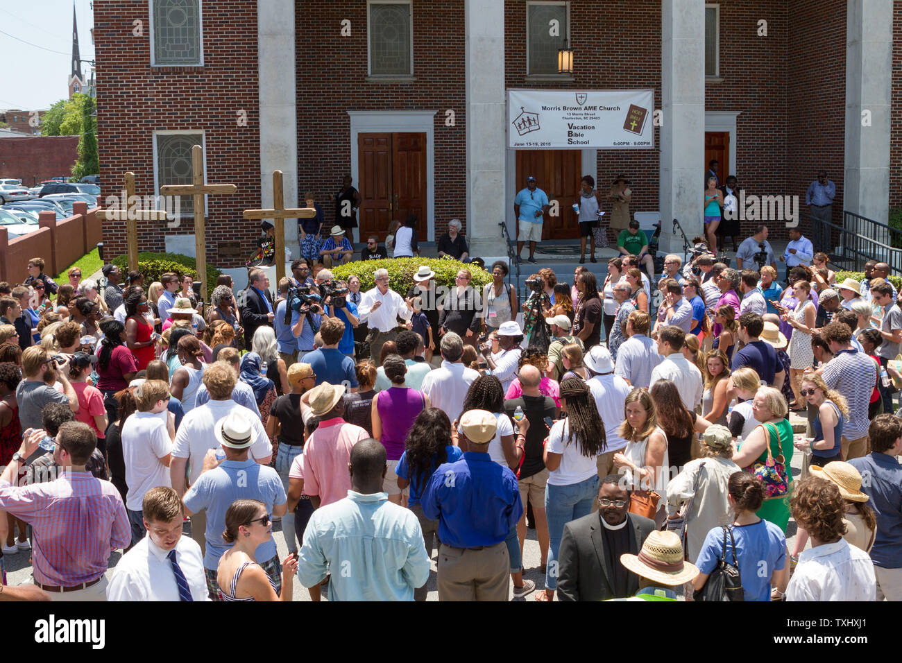 HA local minister leads a crowd in hymns during a prayer vigil outside the Morris Brown AME church in Charleston, South Carolina on June 18, 2015. The vigil attended by hundreds was in honor of the nine people killed by a lone gunman at the Mother Emanuel African Methodist Episcopal Church on June 17, 2015.  The  suspect was captured.  Photo by Gillian Ellis/UPI Stock Photo