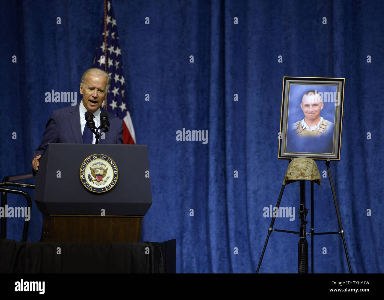 Vice President Joe Biden speaks  in front of a portrait of Gunnery Sergeant Thomas J. Sullivan at a ceremony in remembrance of four Marines and a sailor who were killed in attacks at two military facilities in Chattanooga, Tennessee on August 15, 2015. Photo by Billy Weeks/UPI Stock Photo