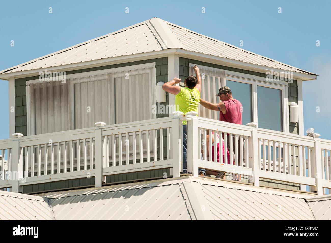 Workers attach hurricane shutters to windows along the beach in preparation for approaching Hurricane Florence September 11, 2018 in Isle of Palms, South Carolina. Florence, a category 4 storm, is expected to hit the coast between South and North Carolina and could be the strongest storm on record for the East Coast of the United States. Photo by Richard Ellis/UPI Stock Photo